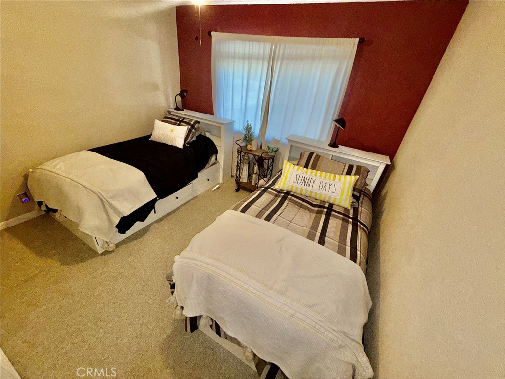 9312 Mountain Meadow Road Shingletown, CA 96088 - Photo 17 of 44 a bedroom with a bed and wooden floor