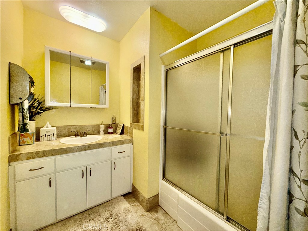 9312 Mountain Meadow Road Shingletown, CA 96088 - Photo 18 of 44 a bathroom with a granite countertop sink and a mirror