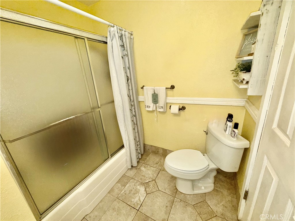 9312 Mountain Meadow Road Shingletown, CA 96088 - Photo 19 of 44 a bathroom with a toilet and a shower