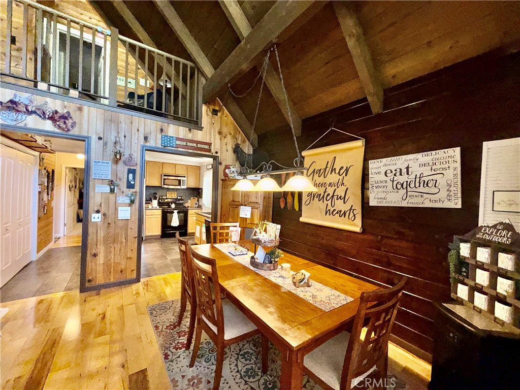 9312 Mountain Meadow Road Shingletown, CA 96088 - Photo 25 of 44 a view of a patio with table and chairs with wooden floor
