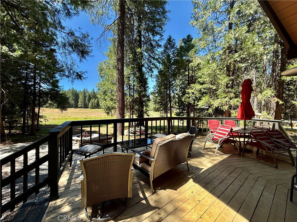 9312 Mountain Meadow Road Shingletown, CA 96088 - Photo 33 of 44 a view of a balcony with chairs and wooden fence