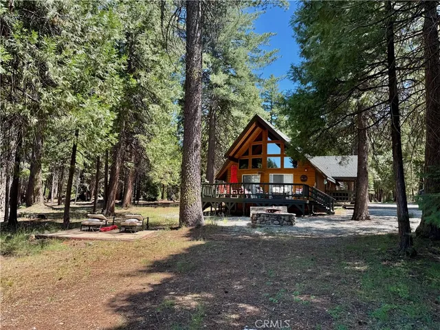 a front view of a house with cars parked
