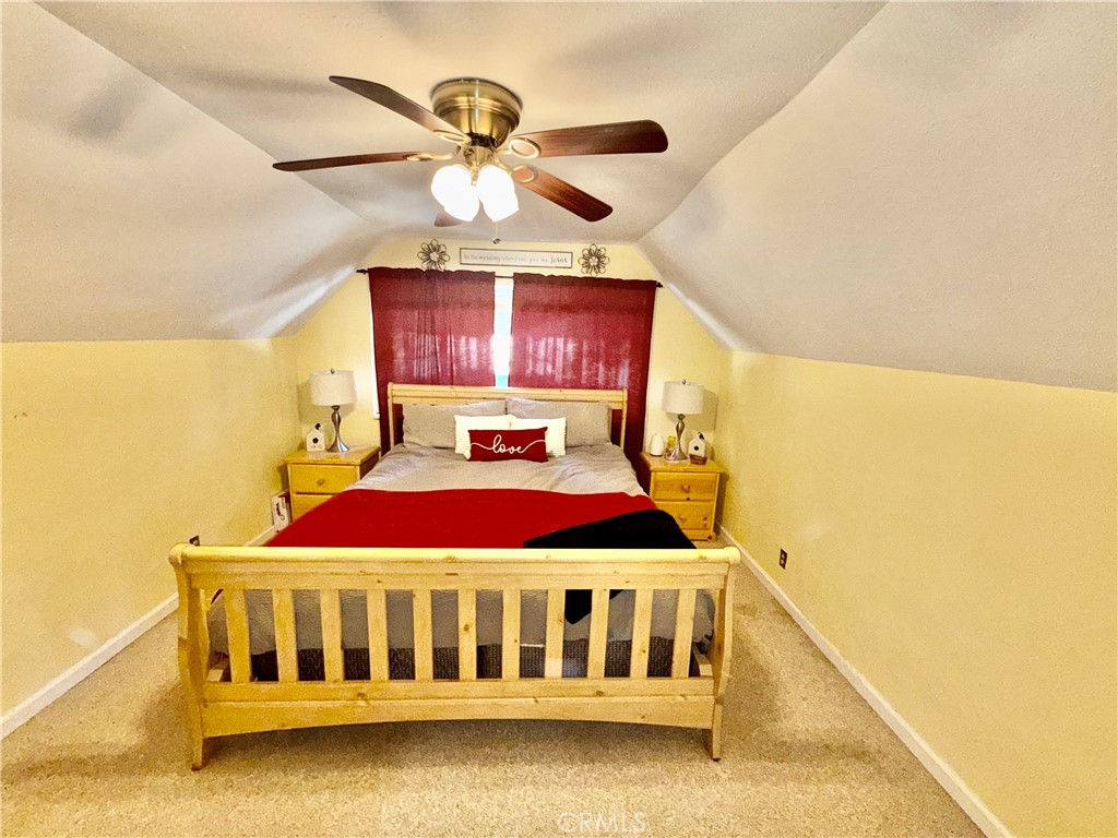 9312 Mountain Meadow Road Shingletown, CA 96088 - Photo 9 of 44 a bedroom with a bed and ceiling fan