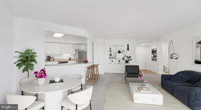 a living room with furniture a rug a flat screen tv and a window