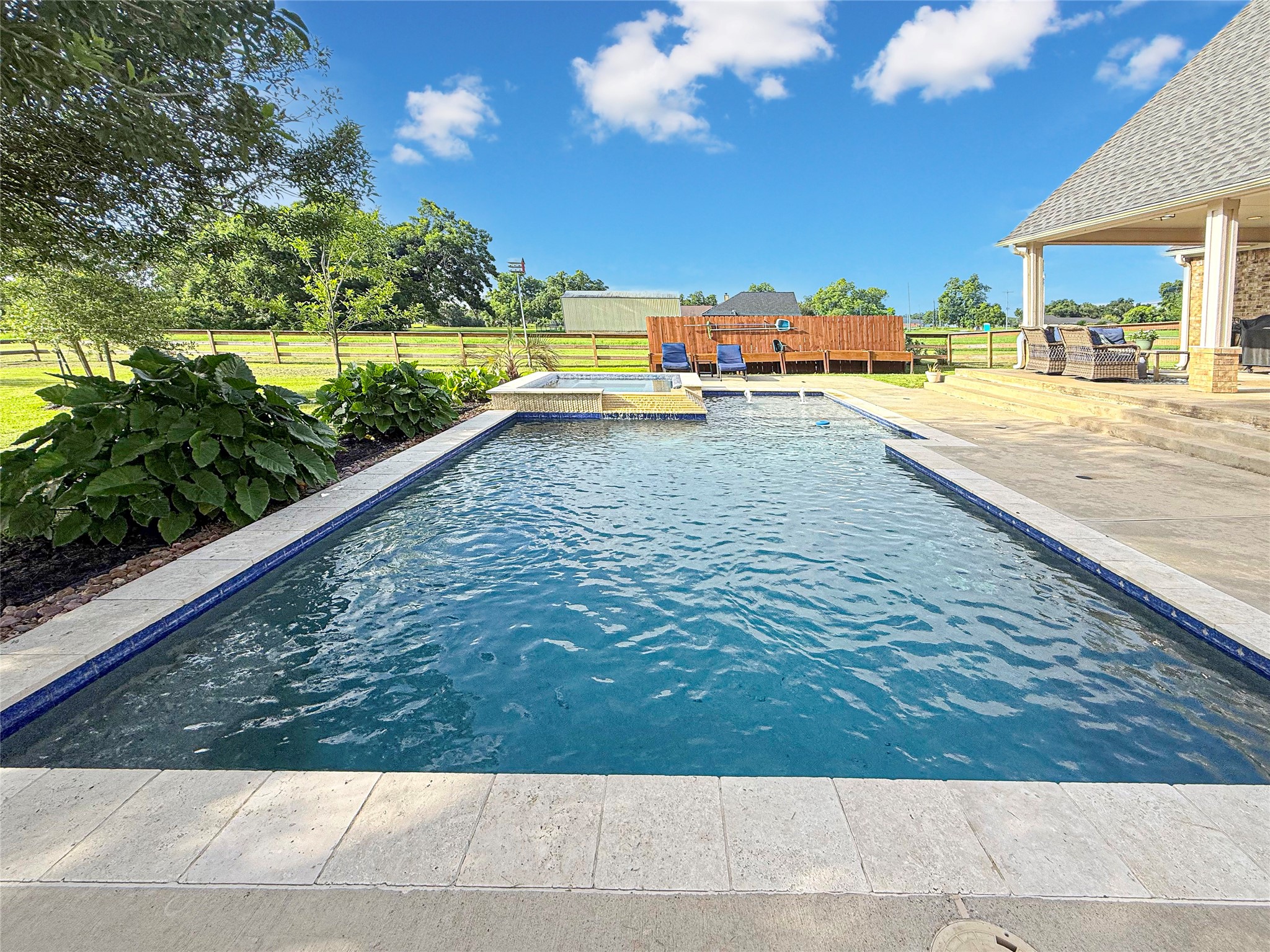 807 Mill Road Angleton, TX 77515 - Photo 4 of 46 Resort-style pool with tanning ledge and fountains.