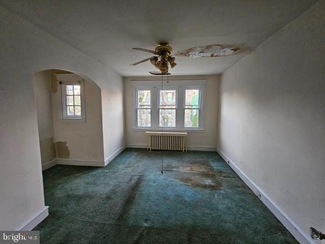 6253 Morton Street Philadelphia, PA 19144 - Photo 14 of 17 an empty room with windows and ceiling fan