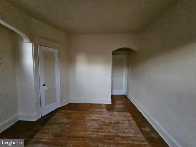 a view of an empty room and wooden floor