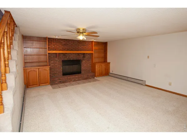 a view of an empty room with stairs