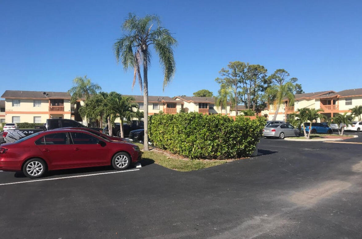 1830 Abbey Road, Unit 105 West Palm Beach, FL 33415 - Photo 1 of 12 a view of a street with a cars parked in front of it