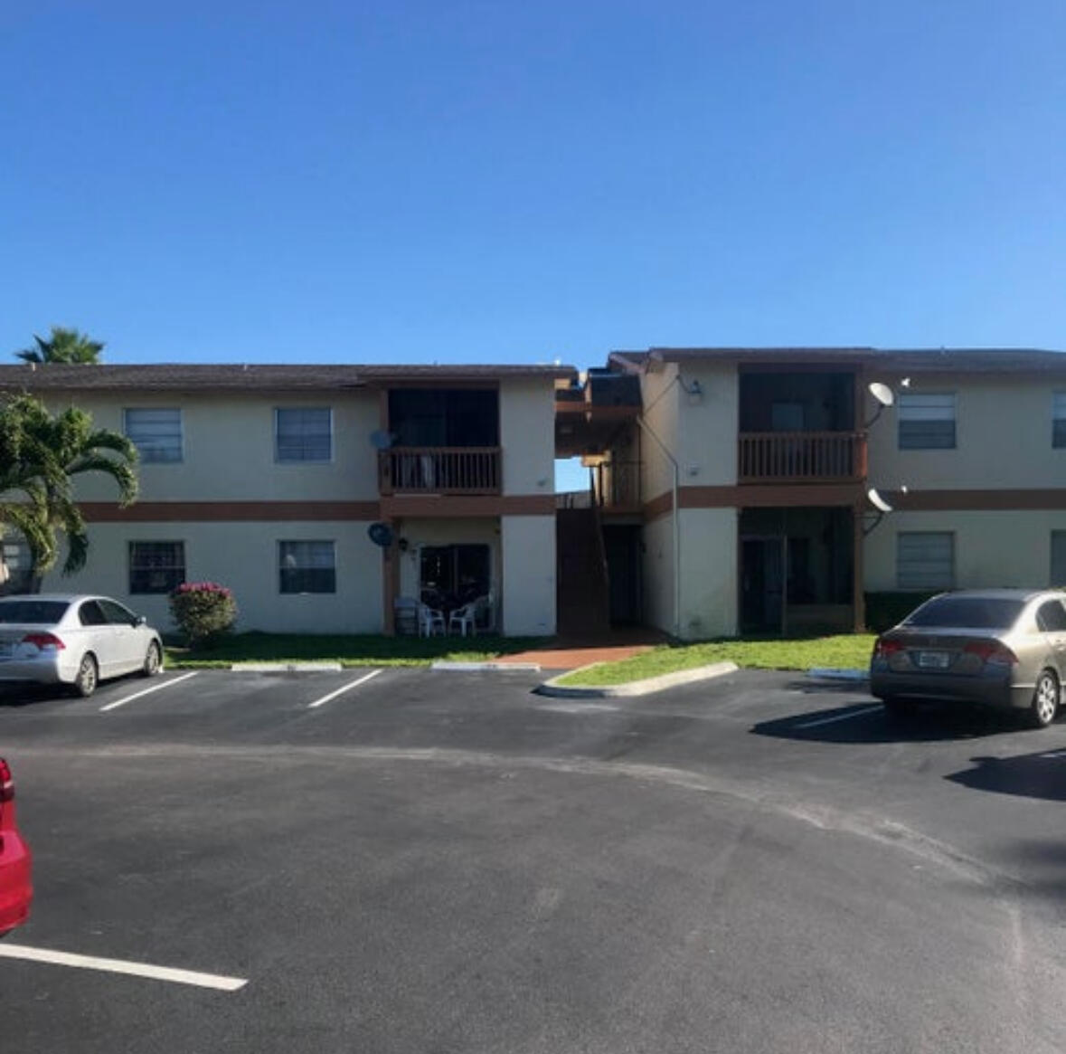 1830 Abbey Road, Unit 105 West Palm Beach, FL 33415 - Photo 2 of 12 a view of street with parked cars