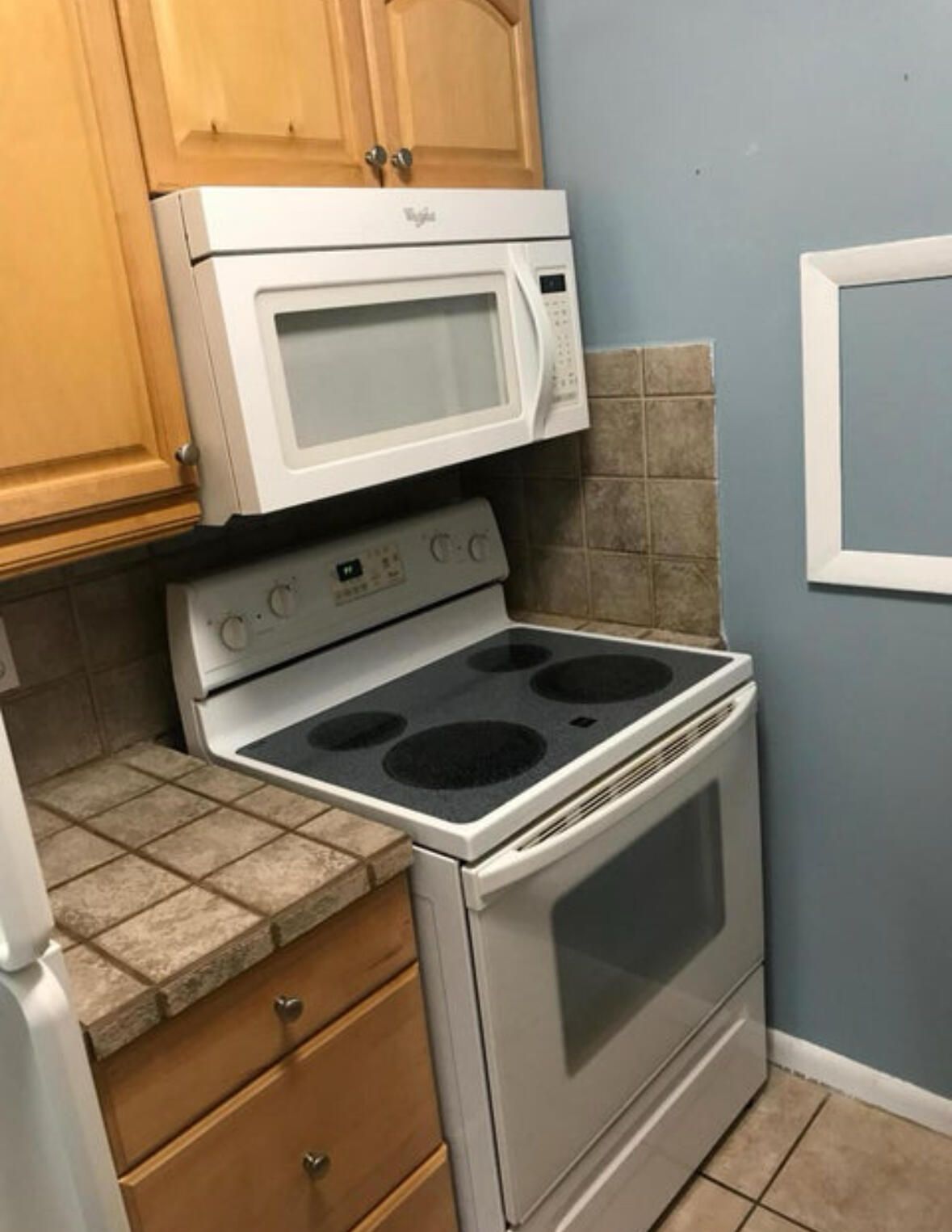1830 Abbey Road, Unit 105 West Palm Beach, FL 33415 - Photo 3 of 12 a stove top oven sitting inside of a kitchen