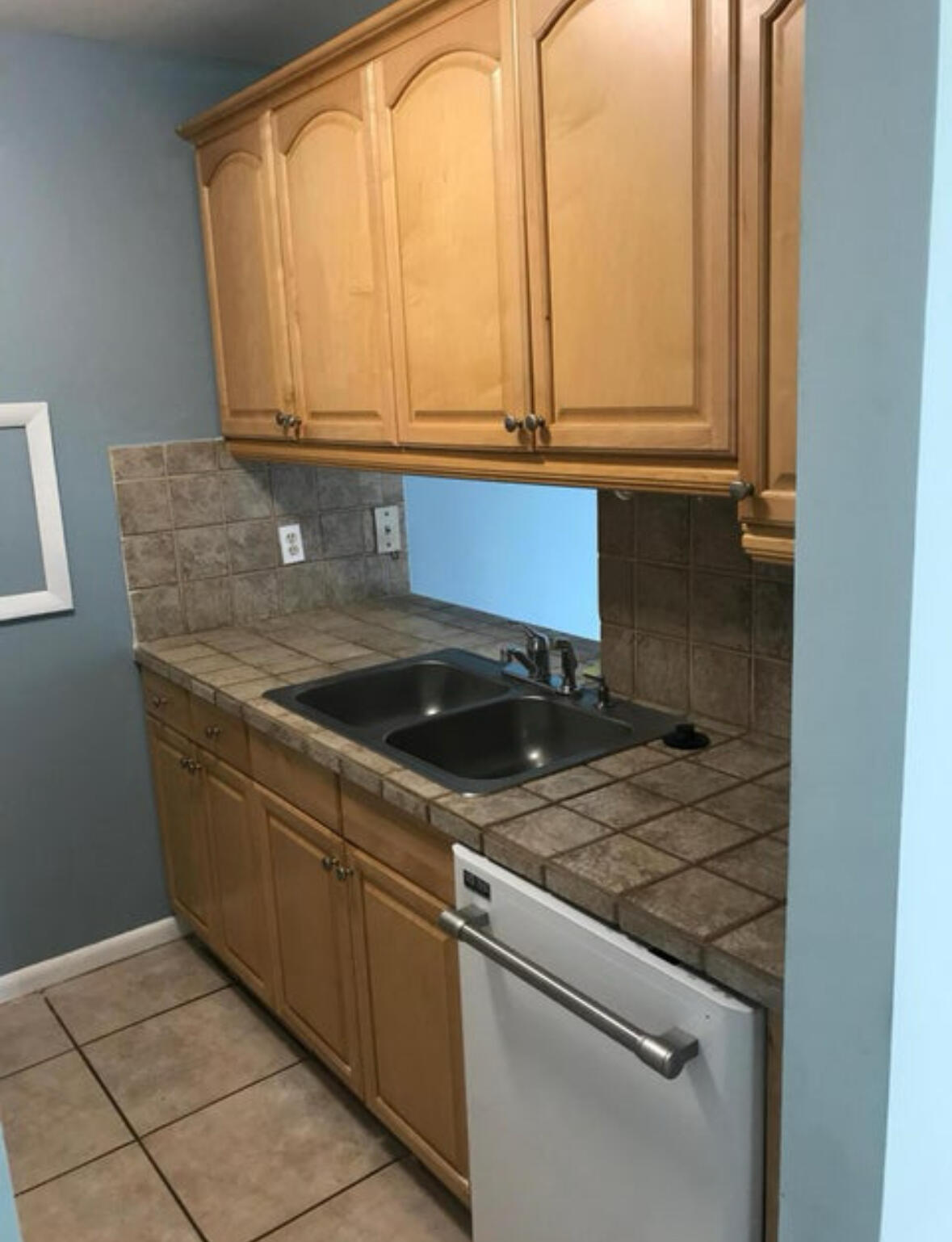 1830 Abbey Road, Unit 105 West Palm Beach, FL 33415 - Photo 4 of 12 a kitchen with stainless steel appliances granite countertop a sink and a white cabinets