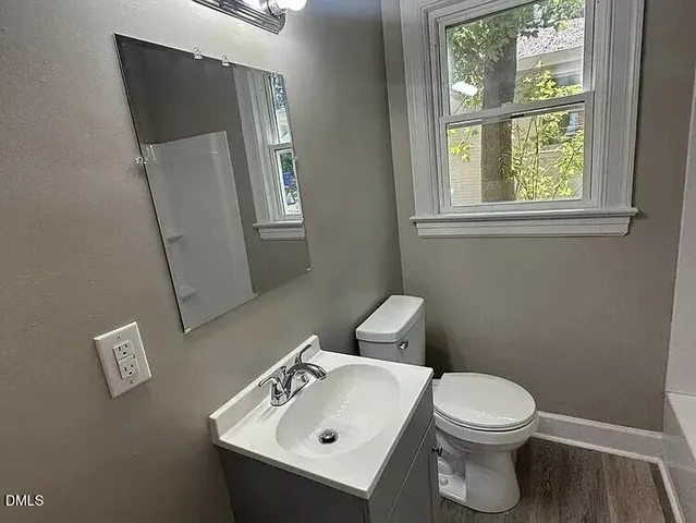 a white toilet sitting next to a bathroom sink