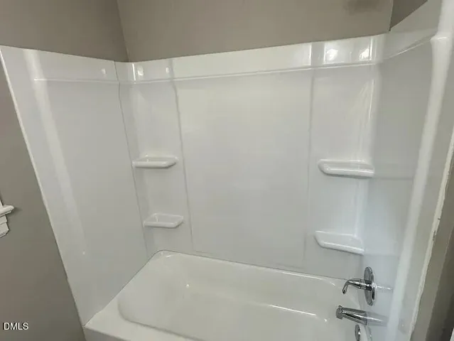 a bathroom with a shower and a bath tub