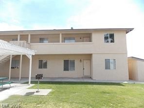 1448 Star Road, Unit 2 Pahrump, NV 89048 - Photo 2 of 10 A well-maintained two-story structure offers comfortable living with a private upper-level balcony and convenient lower-level access.