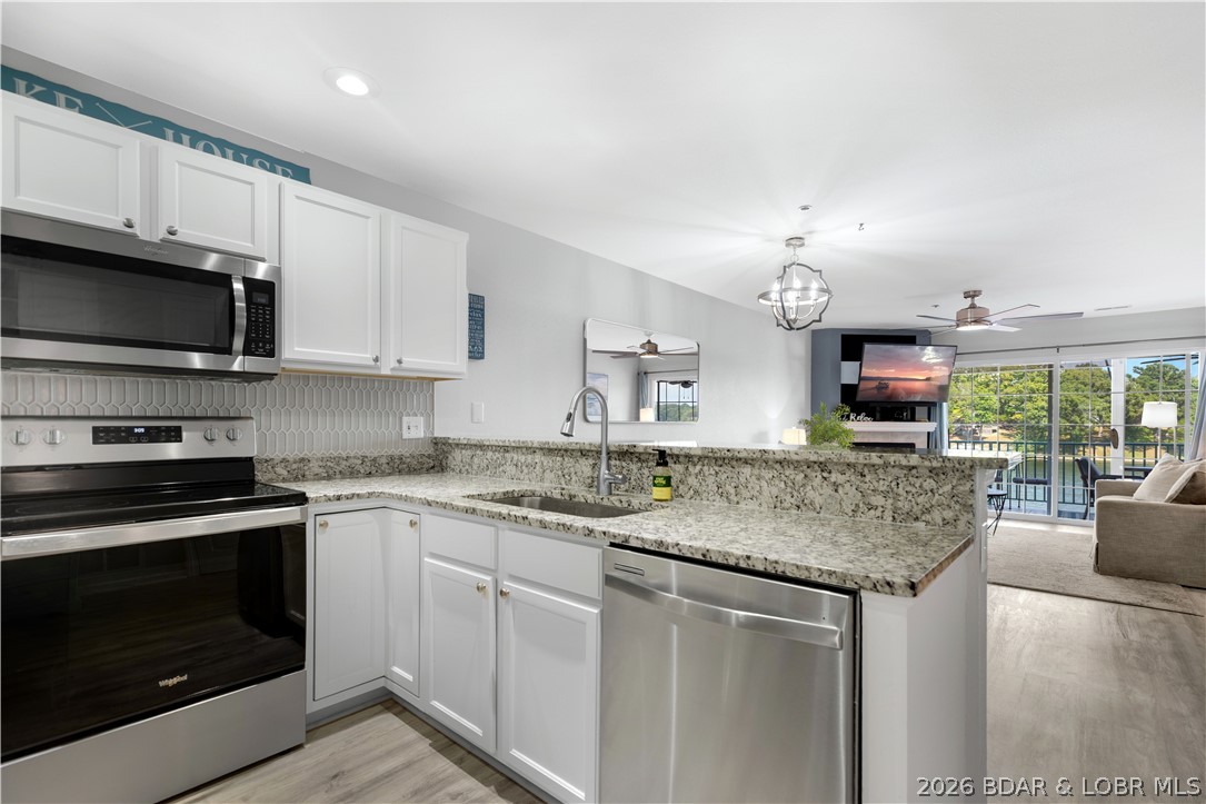 182 Sac Road, Unit C 201 Sunrise Beach, MO 65079 - Photo 11 of 35 Kitchen to Living Room & Deck Access