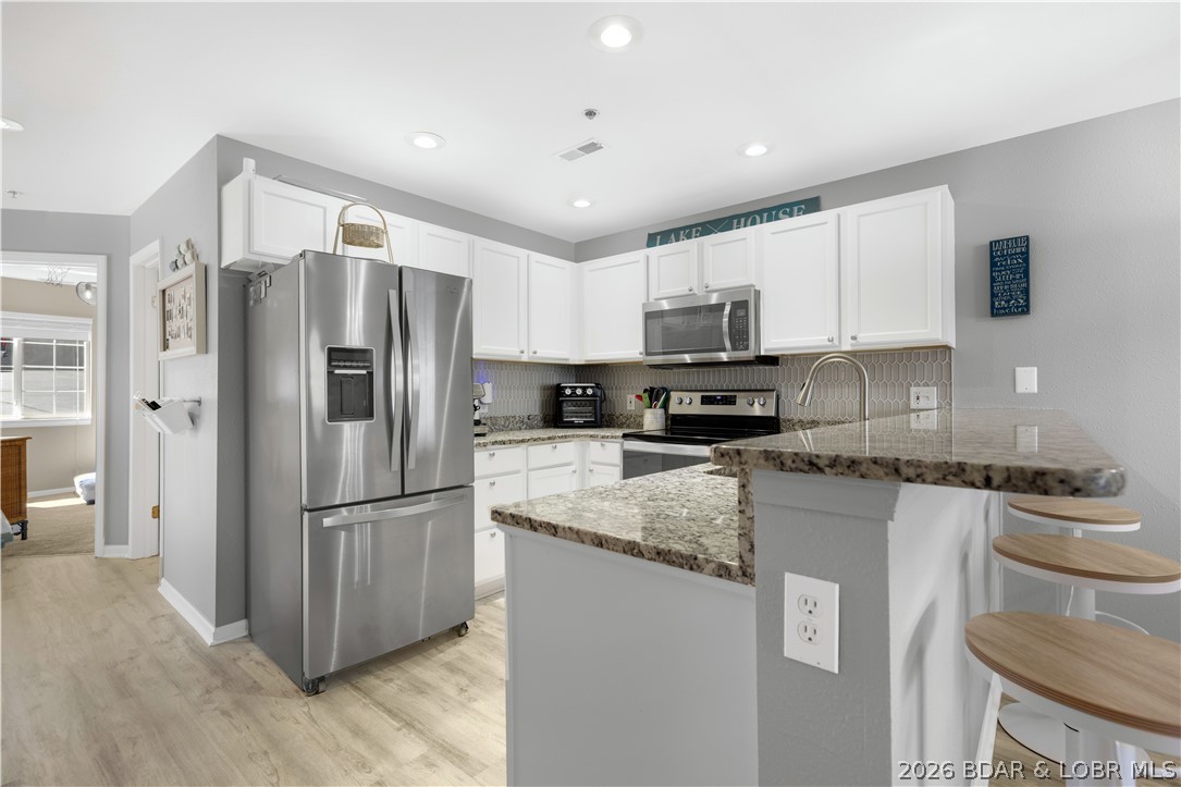 182 Sac Road, Unit C 201 Sunrise Beach, MO 65079 - Photo 9 of 35 Kitchen has Stainless Apps & Granite