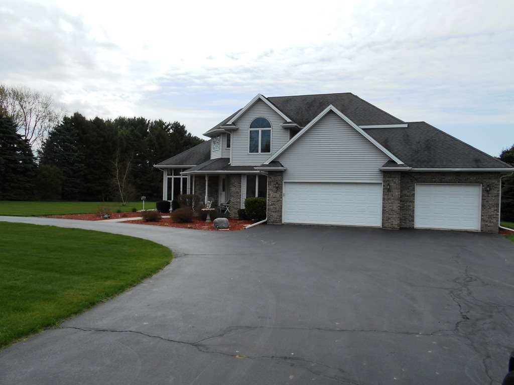 6733 Middle Road South Beloit, IL 61080 - Photo 1 of 19 a house view with a garden space