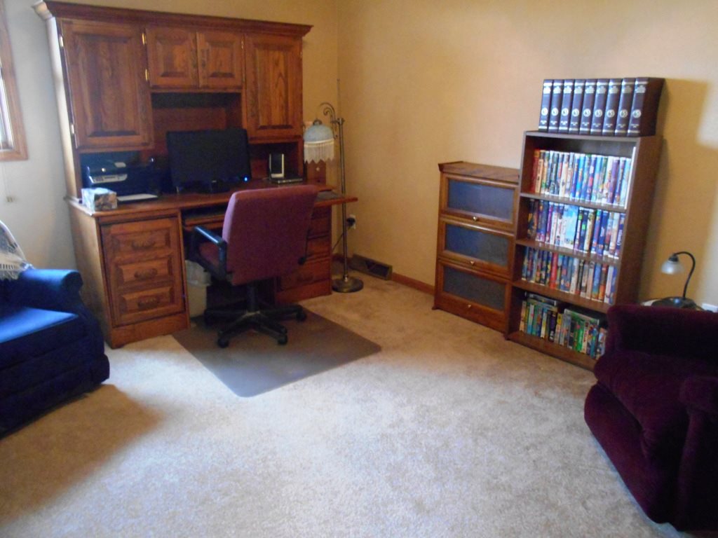 6733 Middle Road South Beloit, IL 61080 - Photo 11 of 19 a room with furniture and a book shelf