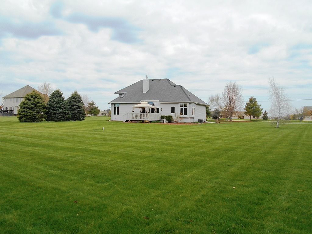 6733 Middle Road South Beloit, IL 61080 - Photo 14 of 19 a view of a house with a big yard and large trees