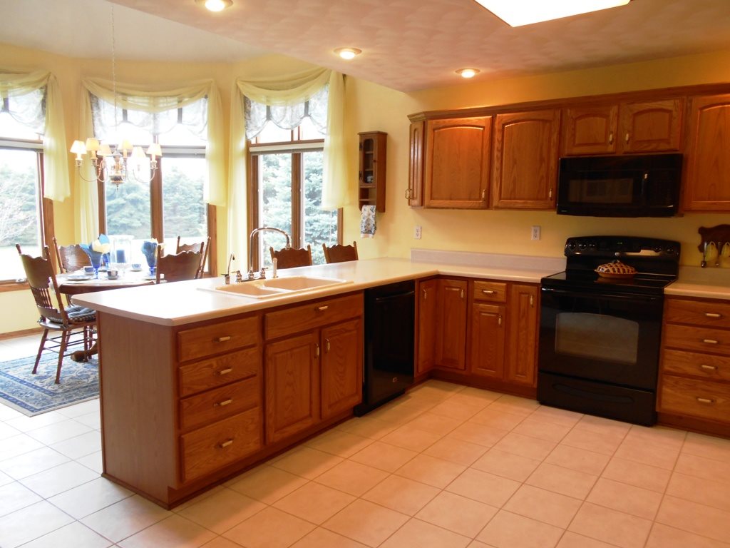 6733 Middle Road South Beloit, IL 61080 - Photo 4 of 19 a kitchen with a sink stove and microwave