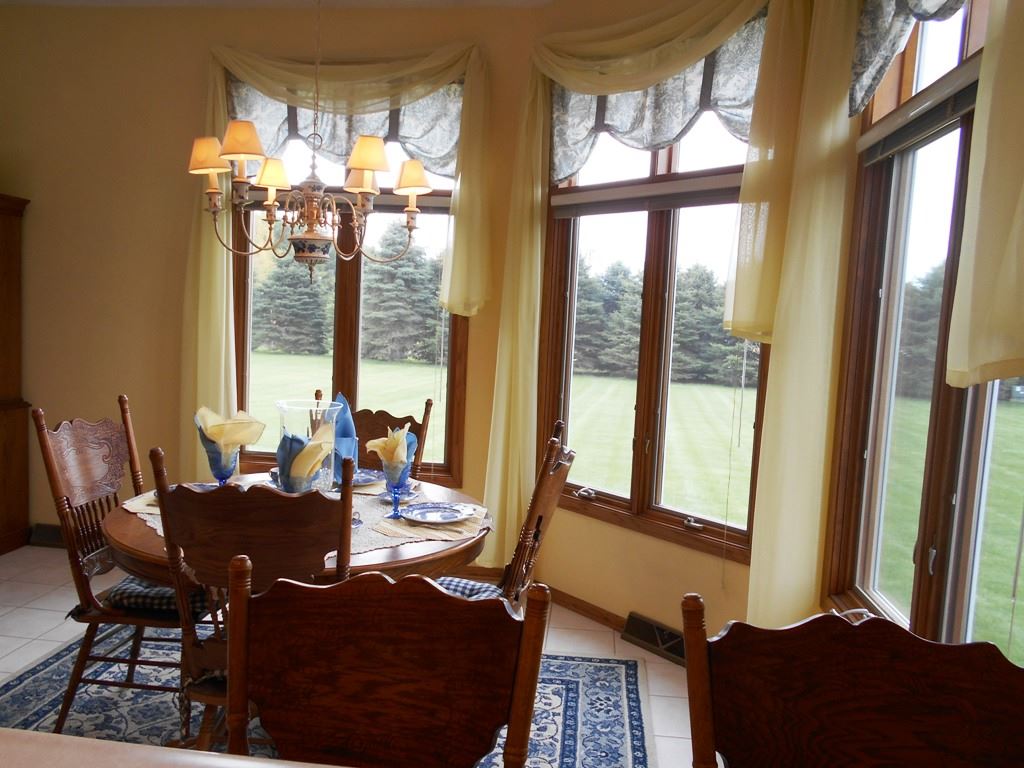 6733 Middle Road South Beloit, IL 61080 - Photo 5 of 19 a view of a dining room with furniture and a potted plant