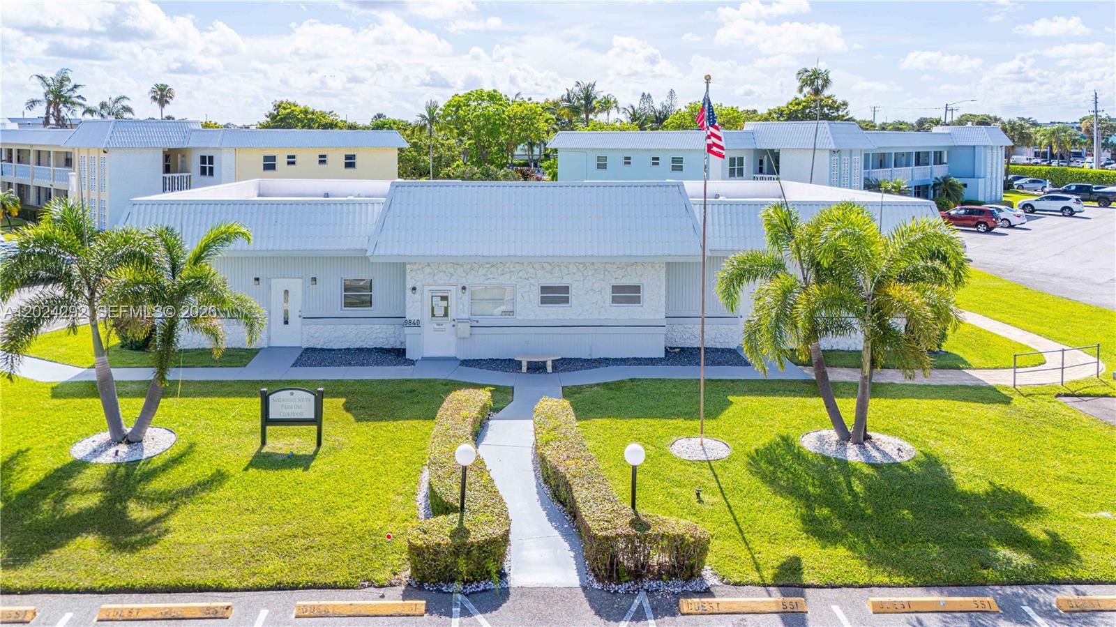 9780 Marina Boulevard, Unit 424 Boca Raton, FL 33428 - Photo 25 of 32 a swimming pool with outdoor seating and yard