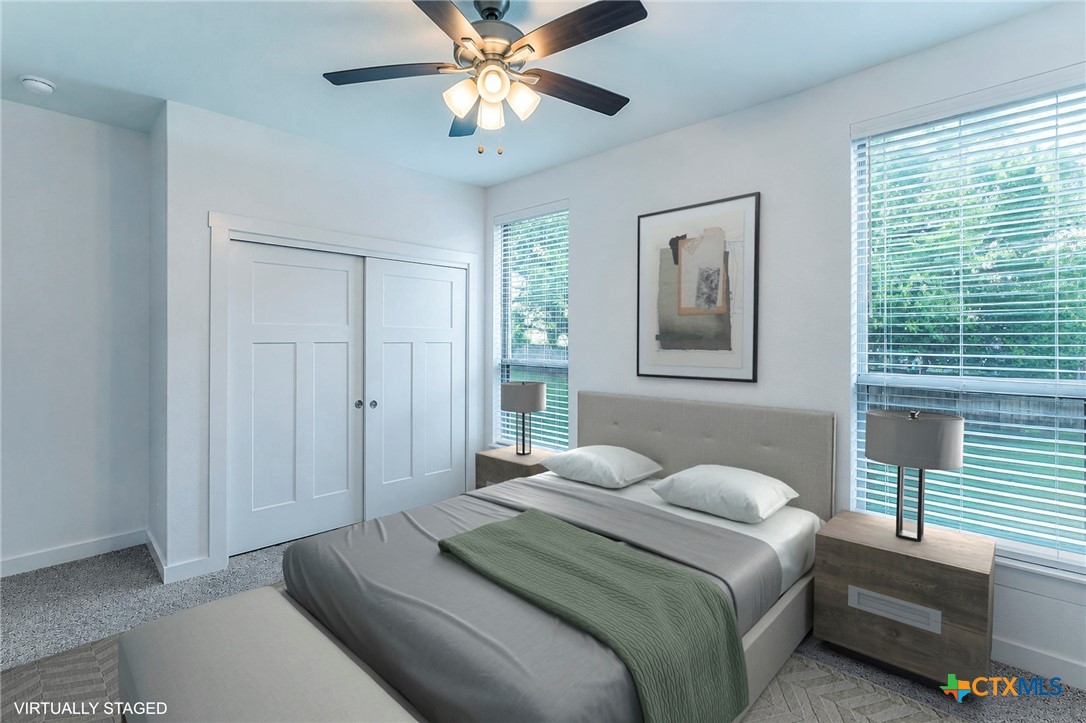 8 Daingerfield Cove Morgan's Point Resort, TX 76513 - Photo 19 of 28 a bedroom with a bed and a chandelier