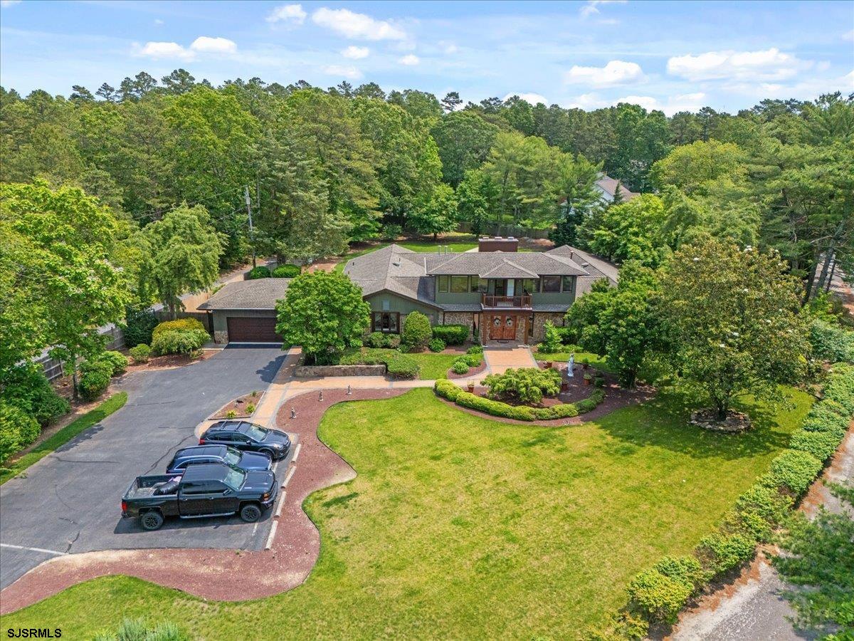 a view of a swimming pool with lawn chairs under an umbrella