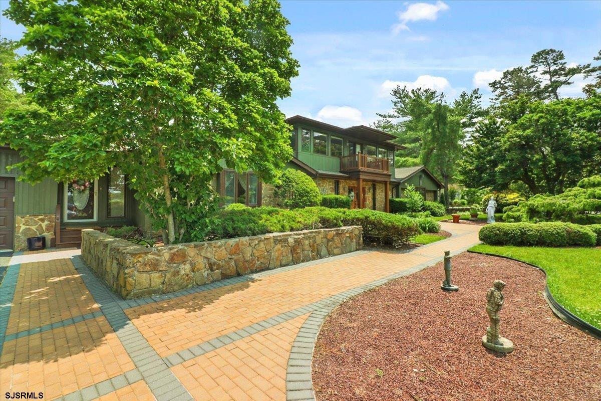 401 Clarkstown Road Mays Landing, NJ 08330 - Photo 11 of 57 a view of a garden with a bench in front of the house