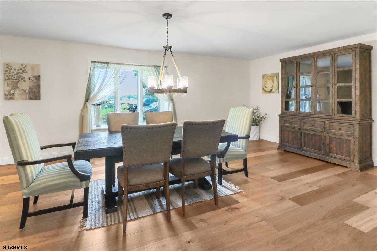 401 Clarkstown Road Mays Landing, NJ 08330 - Photo 16 of 57 a dining room with furniture a chandelier and wooden floor