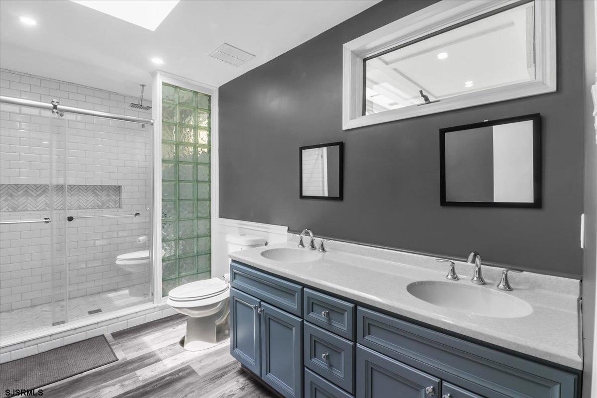 401 Clarkstown Road Mays Landing, NJ 08330 - Photo 19 of 57 a bathroom with a double vanity sink toilet and shower