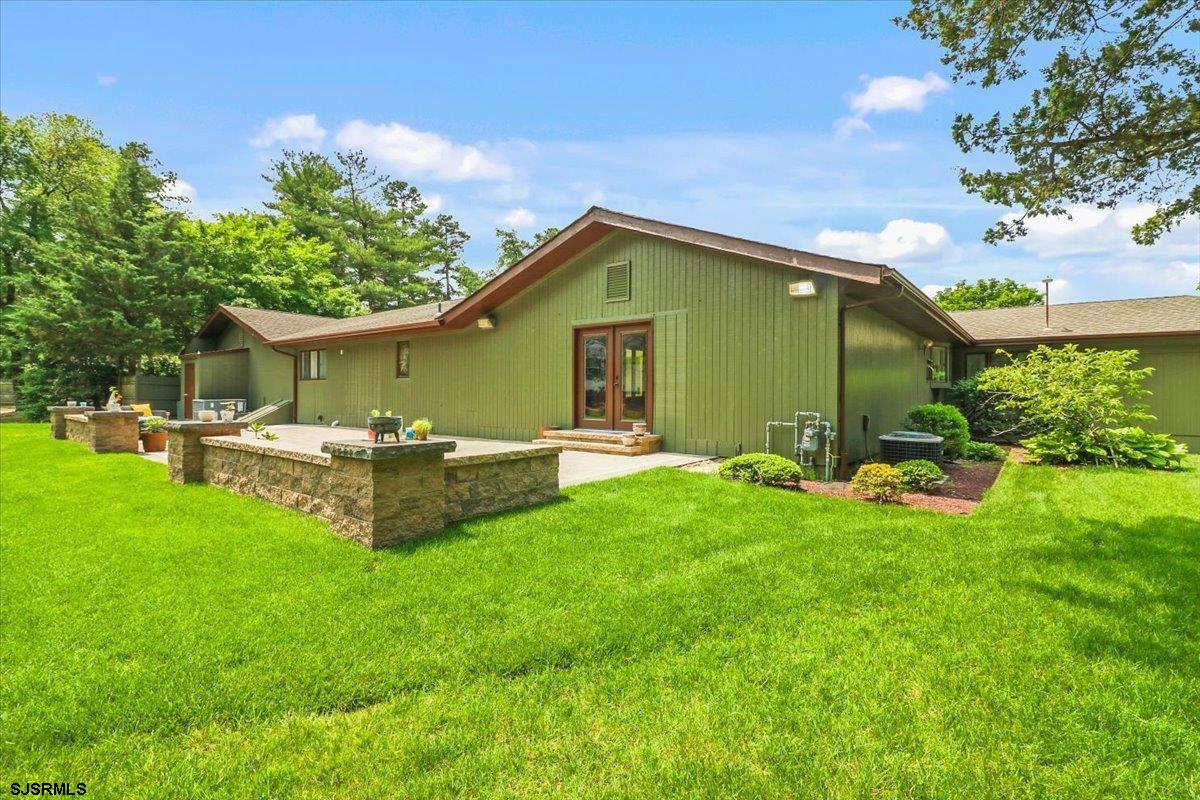 401 Clarkstown Road Mays Landing, NJ 08330 - Photo 20 of 57 a view of a house with a backyard and a patio