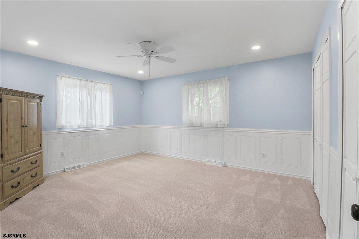 401 Clarkstown Road Mays Landing, NJ 08330 - Photo 38 of 57 an empty room with chandelier fan and windows