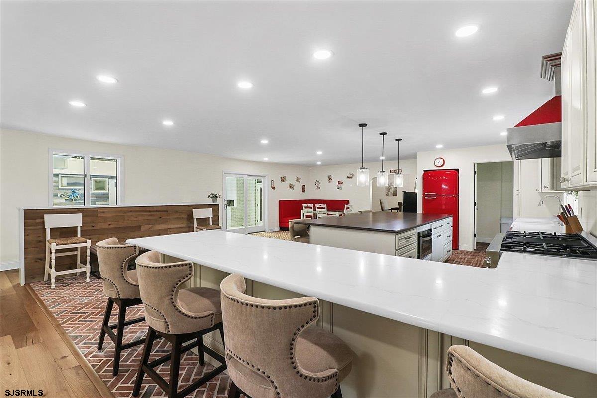 401 Clarkstown Road Mays Landing, NJ 08330 - Photo 4 of 57 a kitchen with kitchen island a stove a table and chairs in it