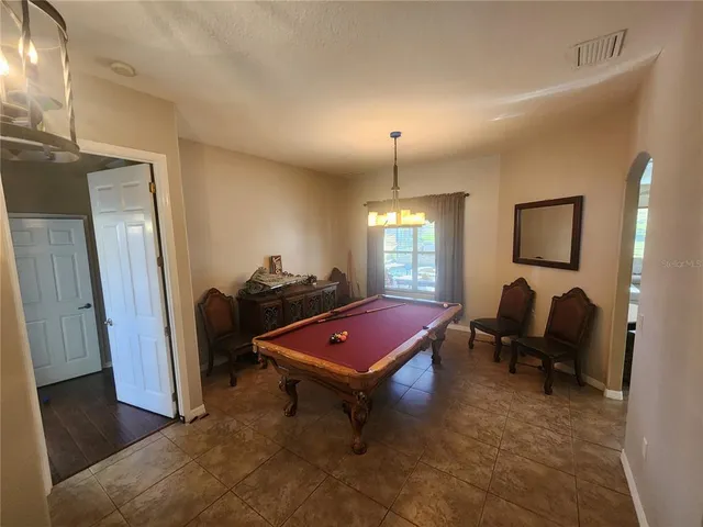 a living room with furniture a rug and a chandelier