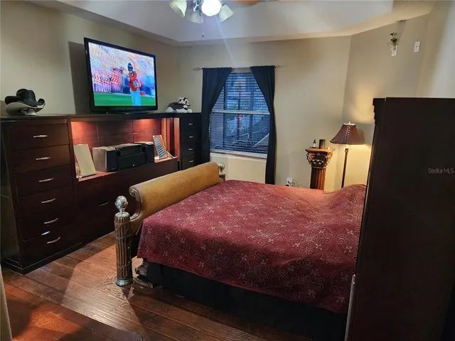 a bed room with a bed and a television