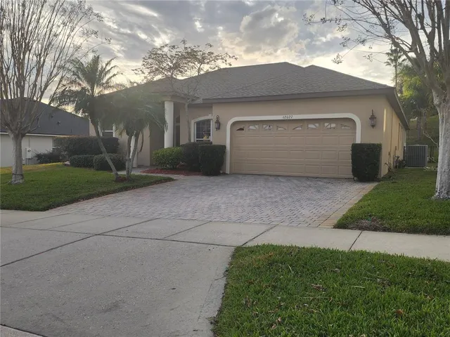 a front view of a house with yard and garage