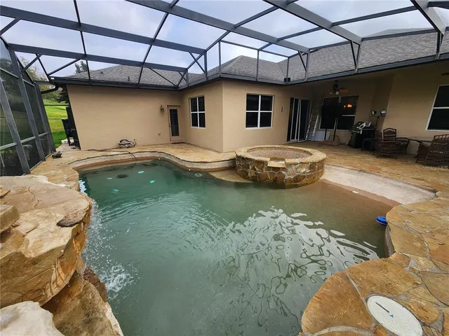 a view of a swimming pool with a patio