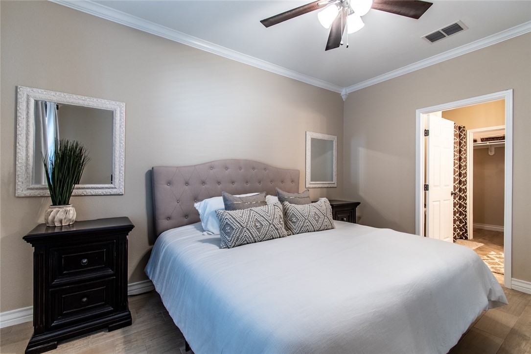 1117 Ninth Street, Unit 803 Port Aransas, TX 78373 - Photo 17 of 27 a bedroom with a bed and a dresser