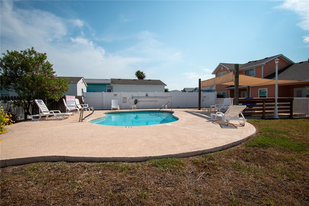 1117 Ninth Street, Unit 803 Port Aransas, TX 78373 - Photo 27 of 27 a view of a house with a yard and sitting area