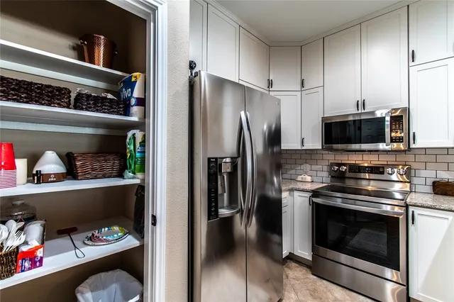 a kitchen with appliances and cabinets