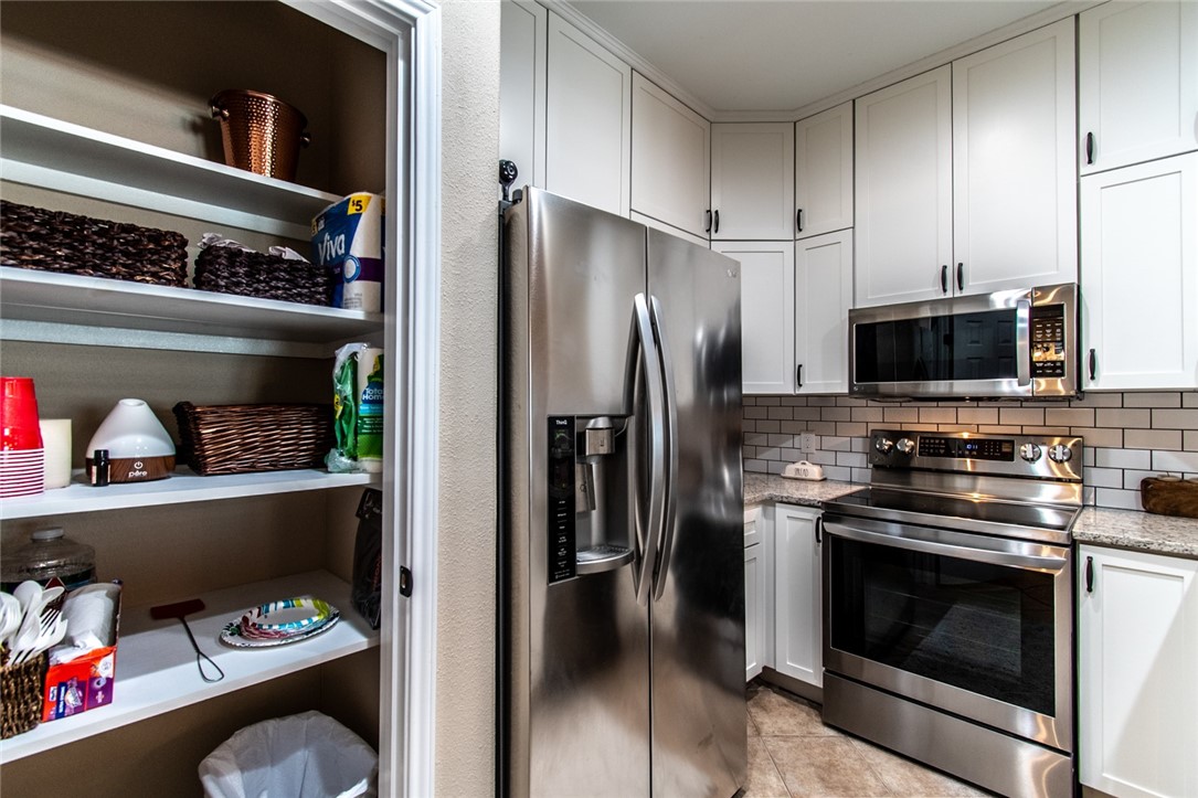 1117 Ninth Street, Unit 803 Port Aransas, TX 78373 - Photo 6 of 27 a kitchen with appliances and cabinets