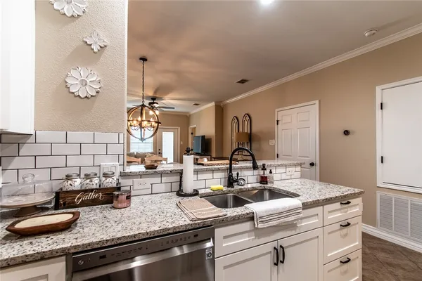 a kitchen with a sink and a refrigerator
