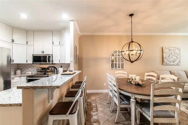 a living room with furniture a chandelier a rug and a window