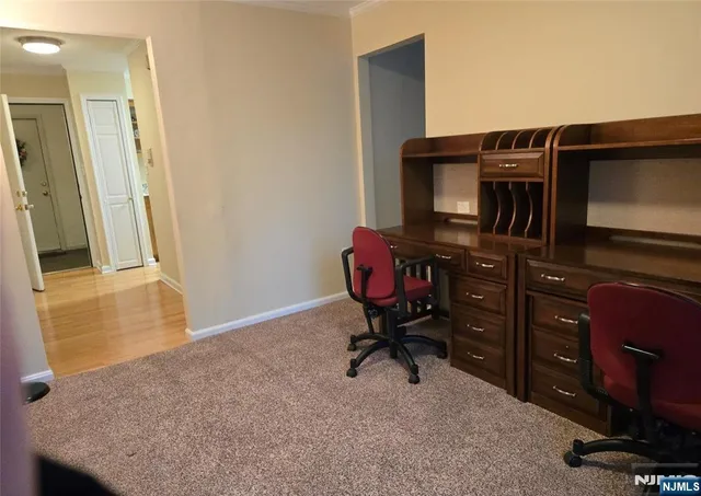 a livingroom with workspace and a window
