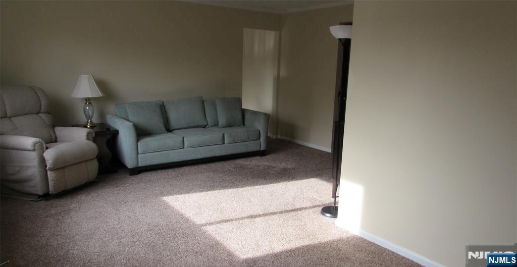 289 Valley Boulevard, Unit 1A Wood-Ridge, NJ 07075 - Photo 3 of 17 a living room with furniture and a rug