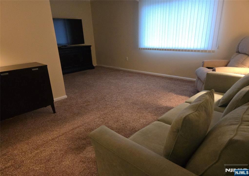 289 Valley Boulevard, Unit 1A Wood-Ridge, NJ 07075 - Photo 7 of 17 a living room with furniture and a window