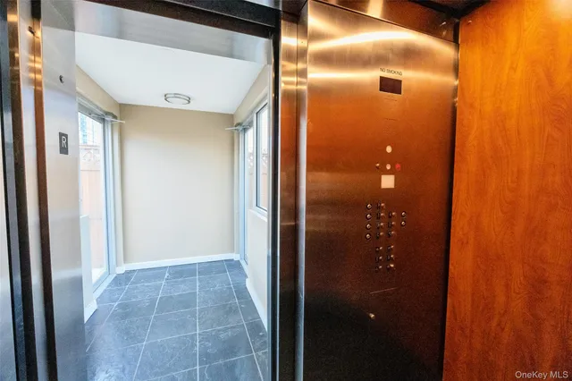 a bathroom with a glass shower door and mirror