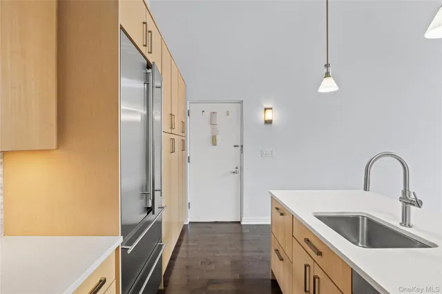 a kitchen with a sink and a refrigerator